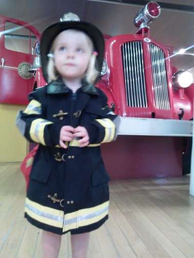 Fiona dresses up like a firefighter at the Staten Island Children's Museum.