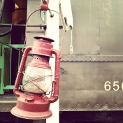 A lantern hangs from a post outside the railway post office car.